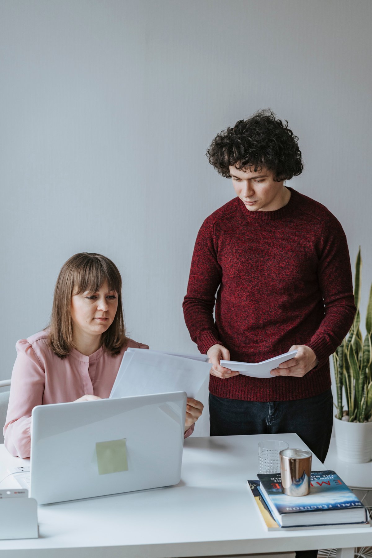 A Man and a Woman Looking at Documents